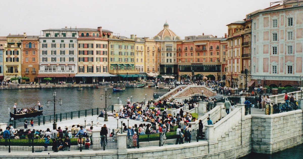 Wide view of Mediterranean Harbor at Tokyo DisneySea with waterfront buildings and crowds