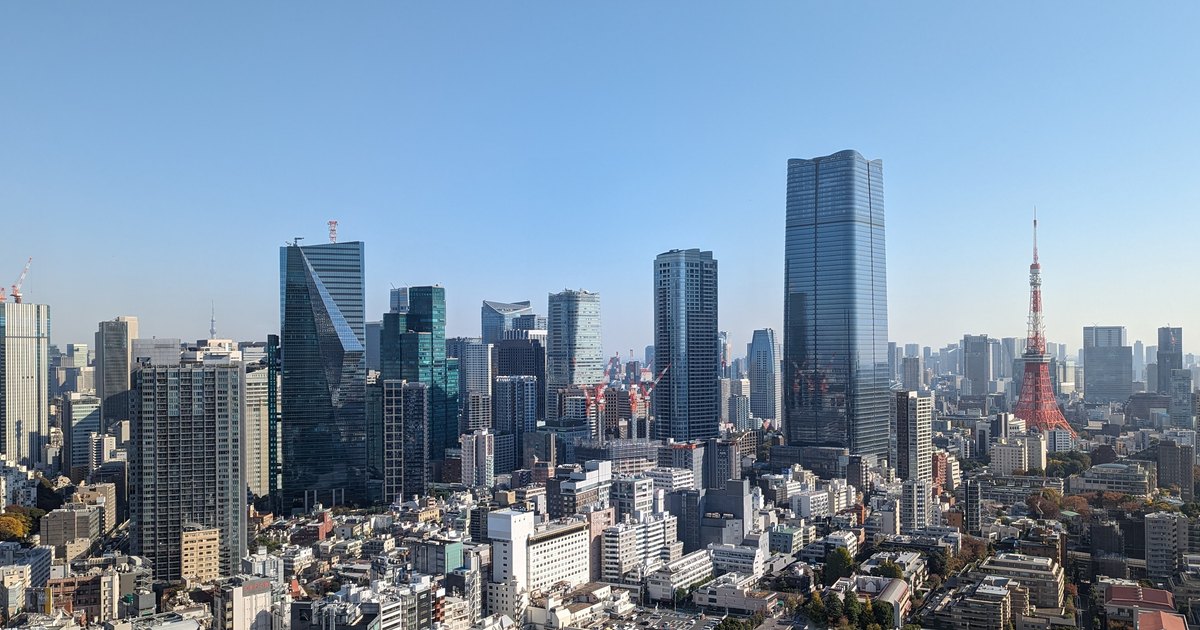 Tokyo skyline with the Azabudai Hills Mori JP Tower and Tokyo Tower under a clear sky