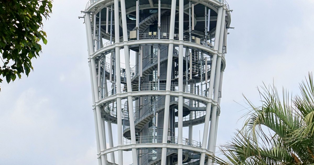The Enoshima Sea Candle observation tower rising above garden trees