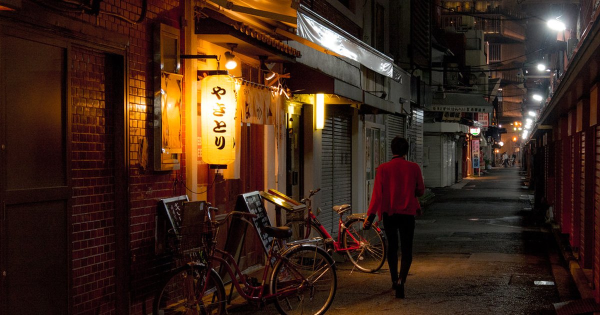 A narrow Asakusa side street at night with a glowing paper lantern outside a yakitori shop