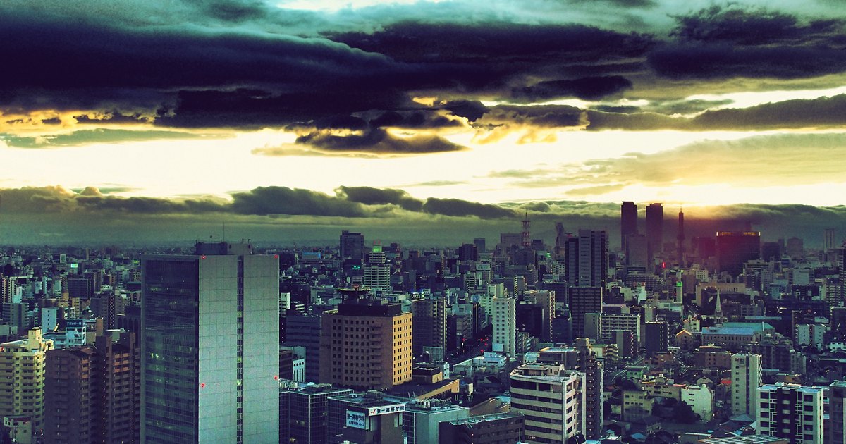 Heavy storm clouds breaking over the Nagoya skyline at sunset after a typhoon
