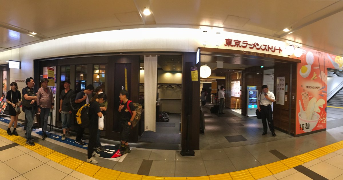 People waiting outside ramen shops in an underground corridor at Tokyo Station