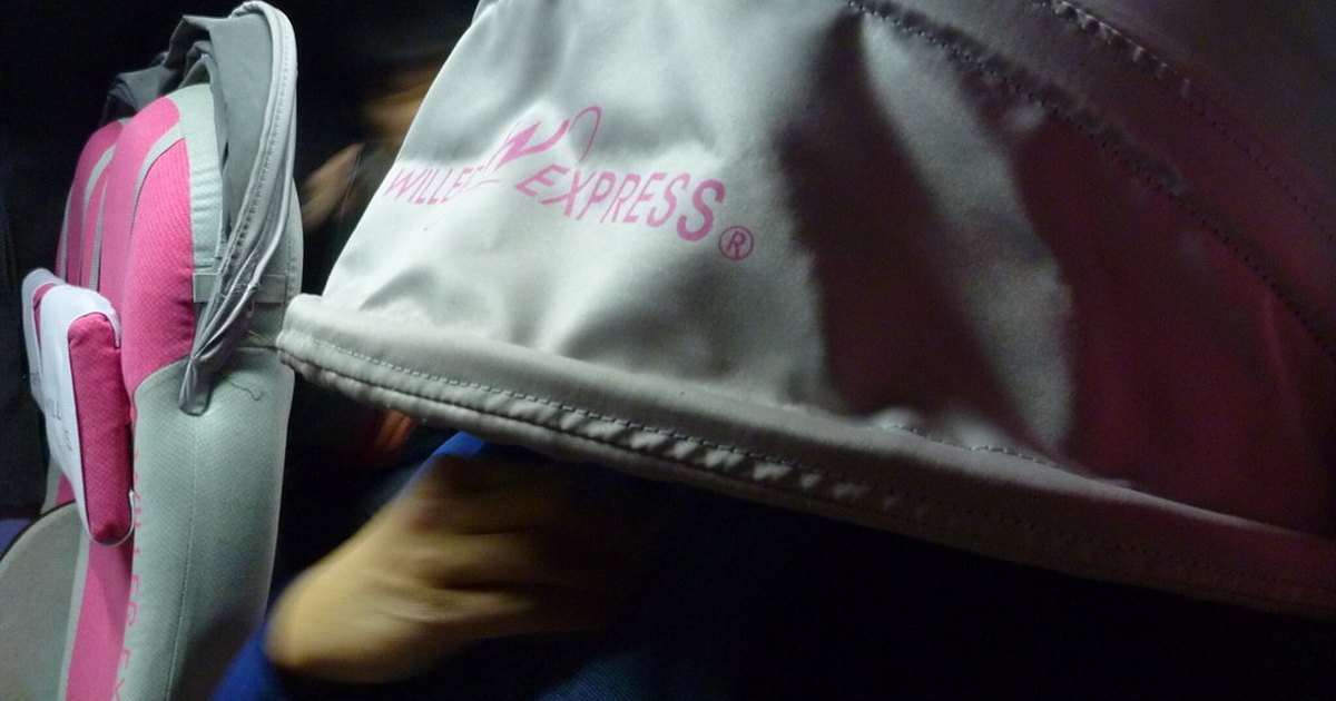 WILLER Express bus seat with its signature canopy hood pulled down over a resting passenger
