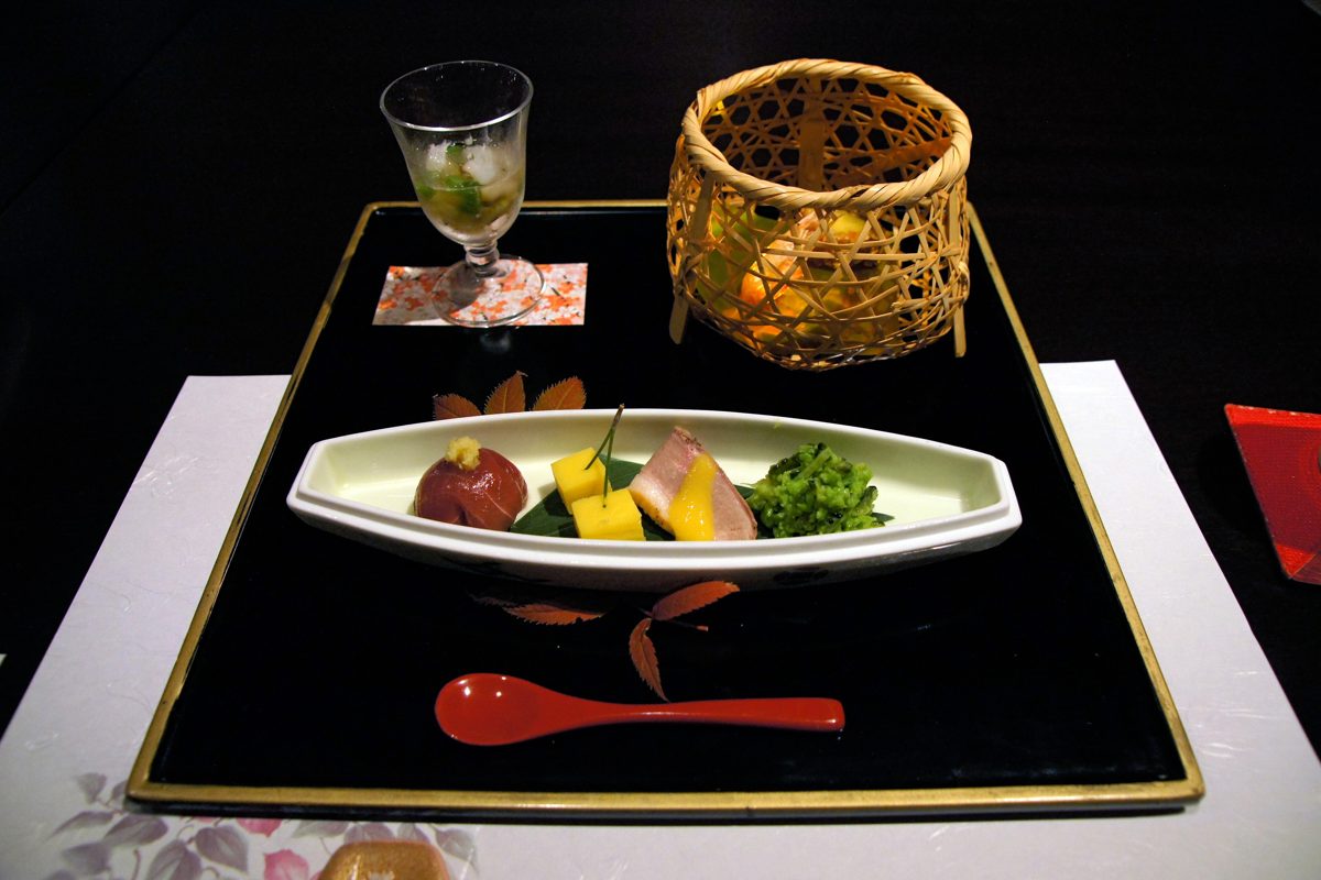 A kaiseki hassun course on a black lacquer tray with small seasonal dishes