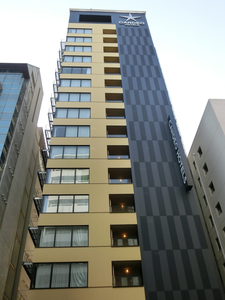 Exterior of Candeo Hotels Osaka Namba with the Candeo Hotels sign on its side
