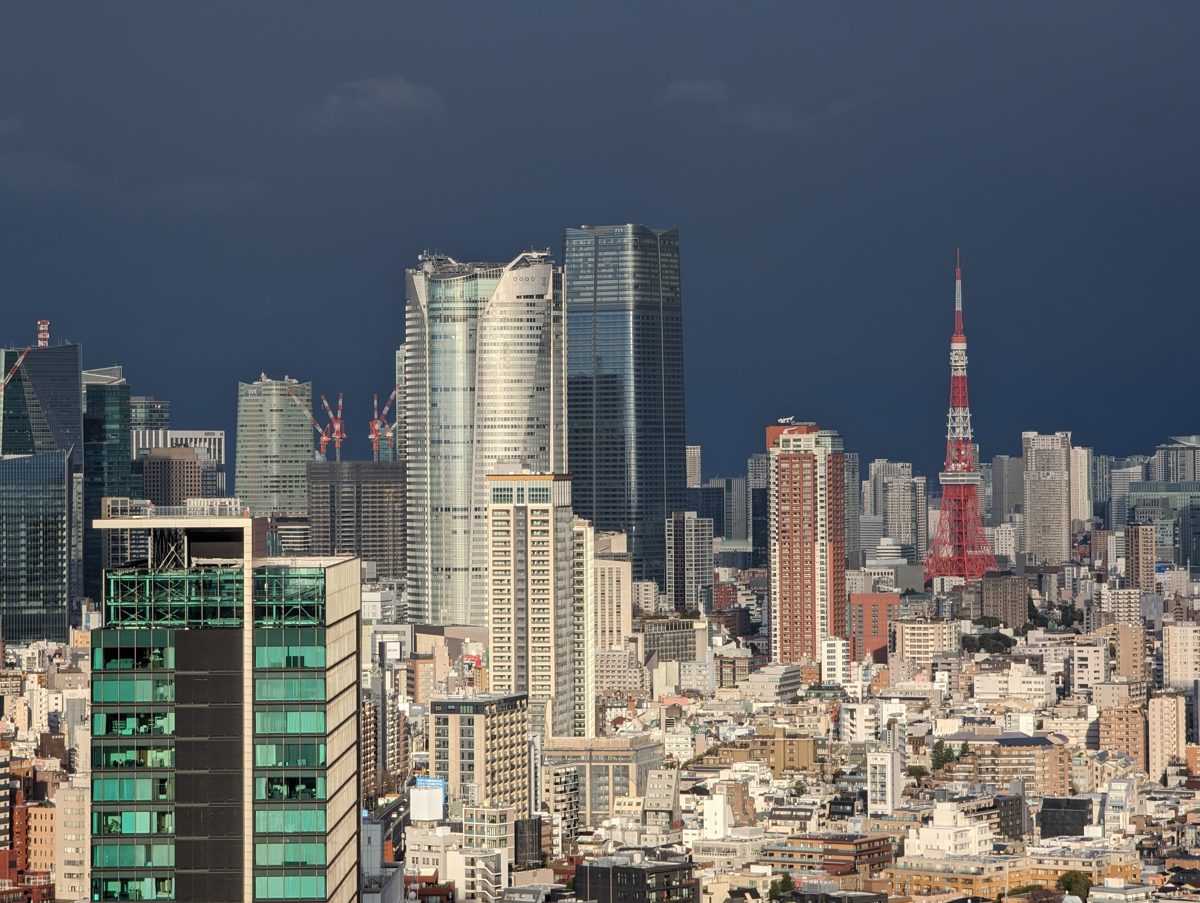 Roppongi Hills and Tokyo Tower above the Tokyo skyline under a dark sky