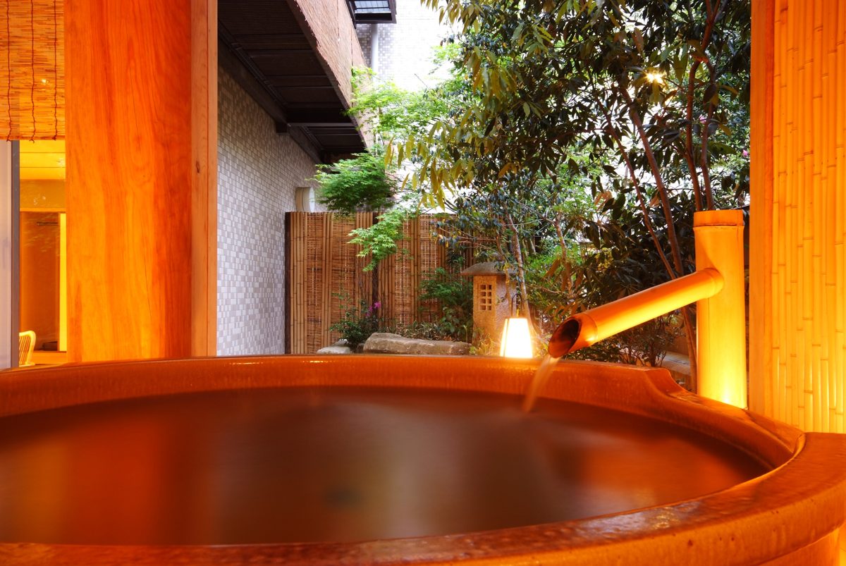 Round wooden hotel bath with steam