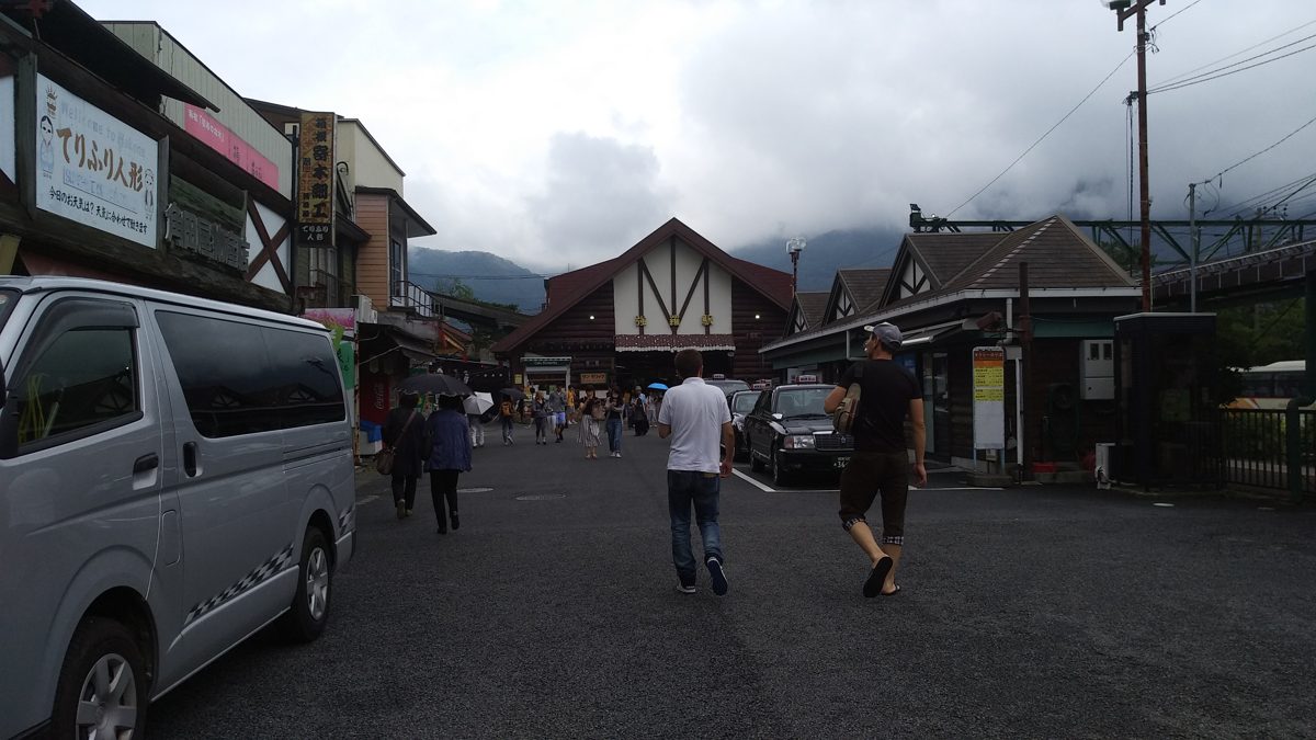 The chalet-style building of Gora Station and the street in front of it, with mountains in cloud behind