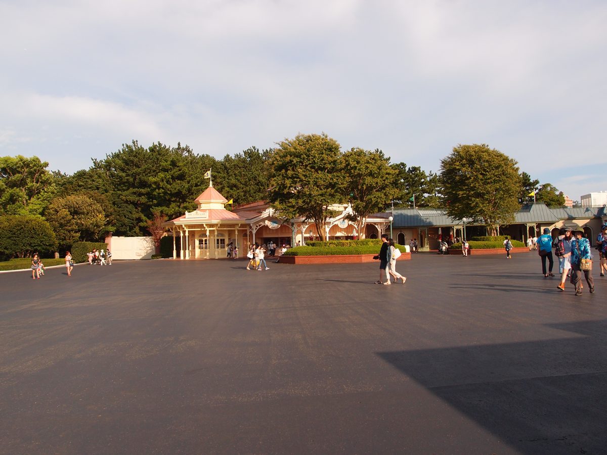 An open plaza with trees and small pavilions at Tokyo Disney Resort in Maihama