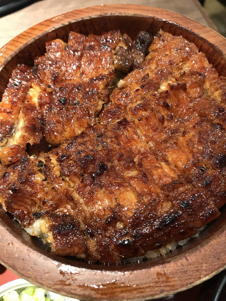 Grilled eel over rice in a round wooden ohitsu tub