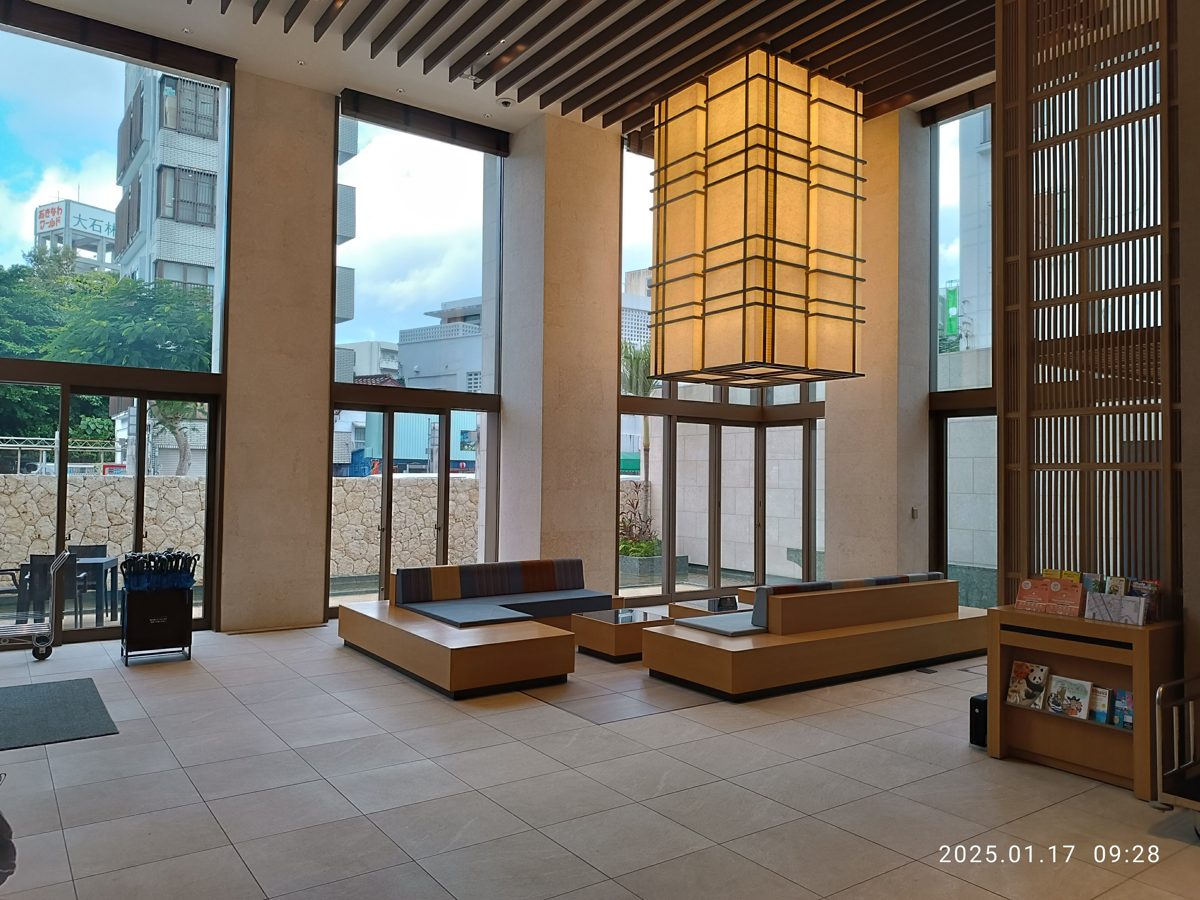 A bright hotel lobby with a paper lantern in Naha