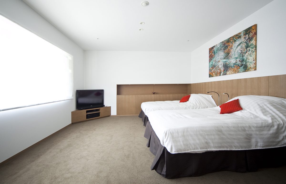 Two beds side by side in a bright western-style twin room