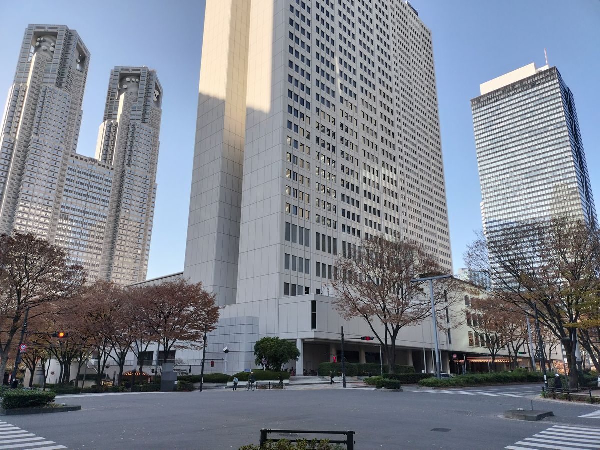 White high-rise towers at a quiet crossing in Nishi-Shinjuku