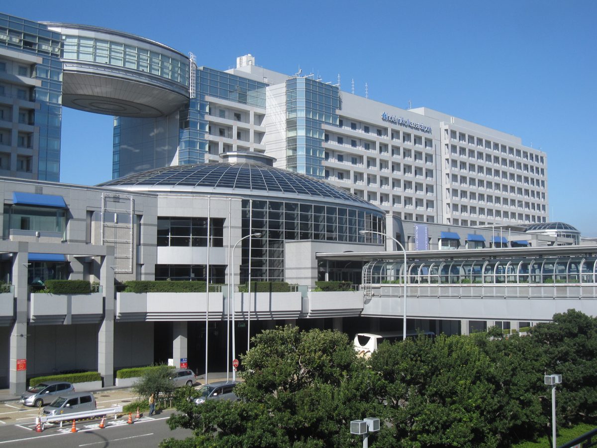 The Hotel Nikko Kansai Airport building behind the AeroPlaza complex under a blue sky