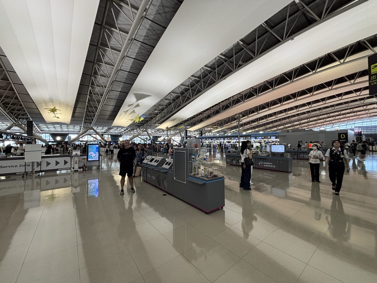 The Terminal 1 departures hall at Kansai International Airport under its long curved roof