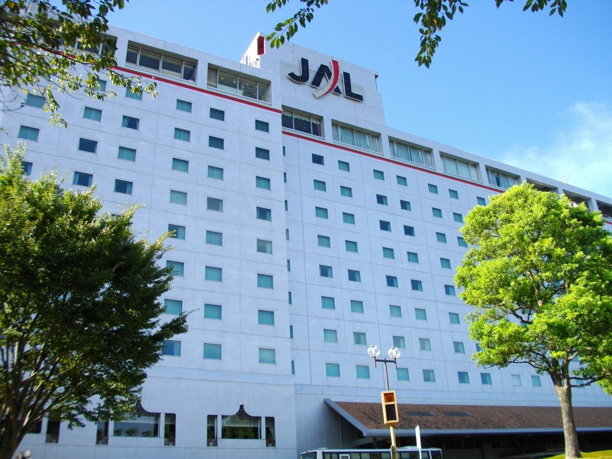 Exterior of Hotel Nikko Narita, a white multi-story building framed by trees