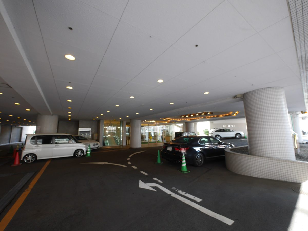 Cars parked under the covered entrance of a Japanese city hotel
