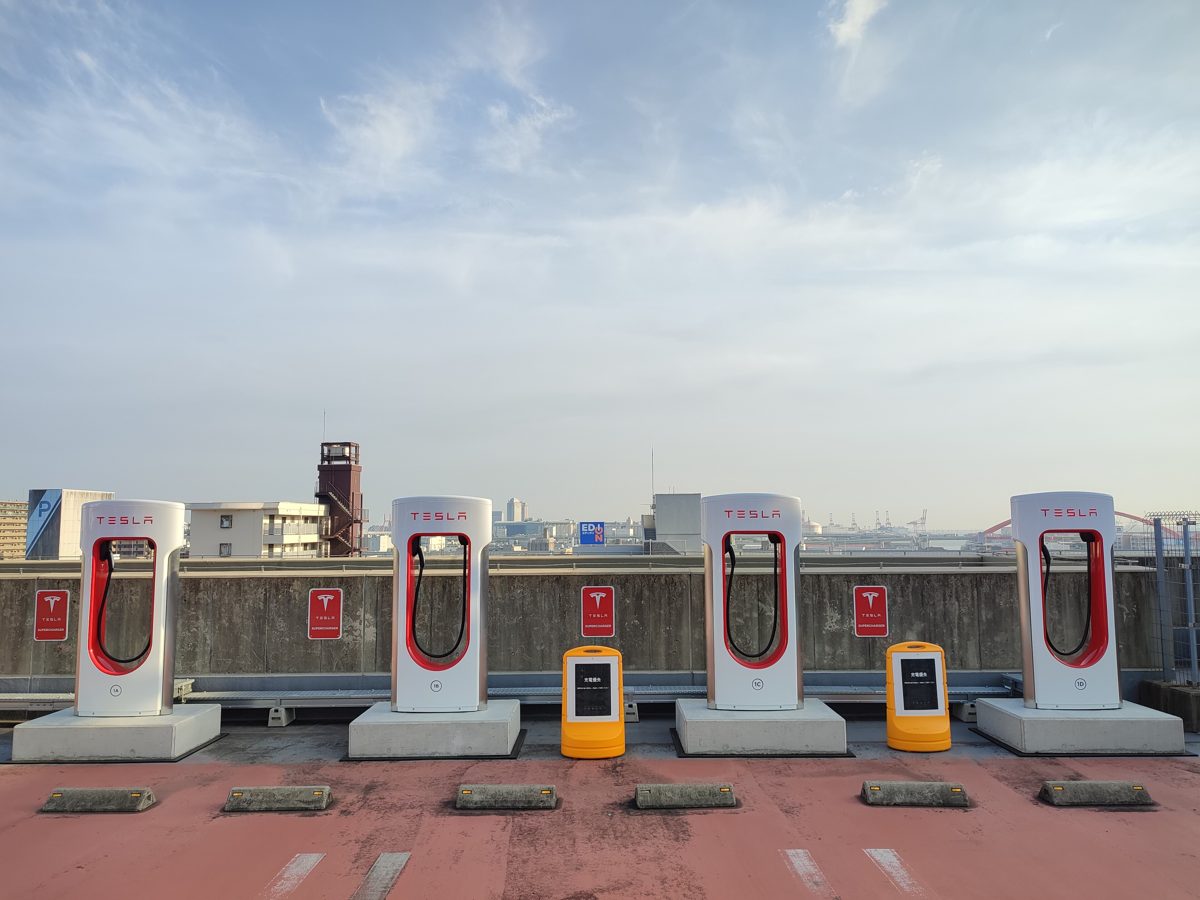 Four Tesla Superchargers on the roof deck of a car park in Kobe