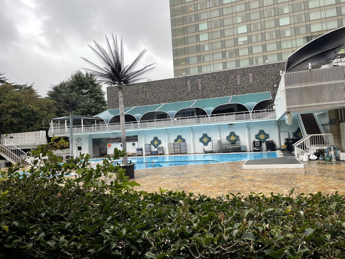 The outdoor Garden Pool at Hotel New Otani Tokyo, with a palm tree and the hotel tower behind