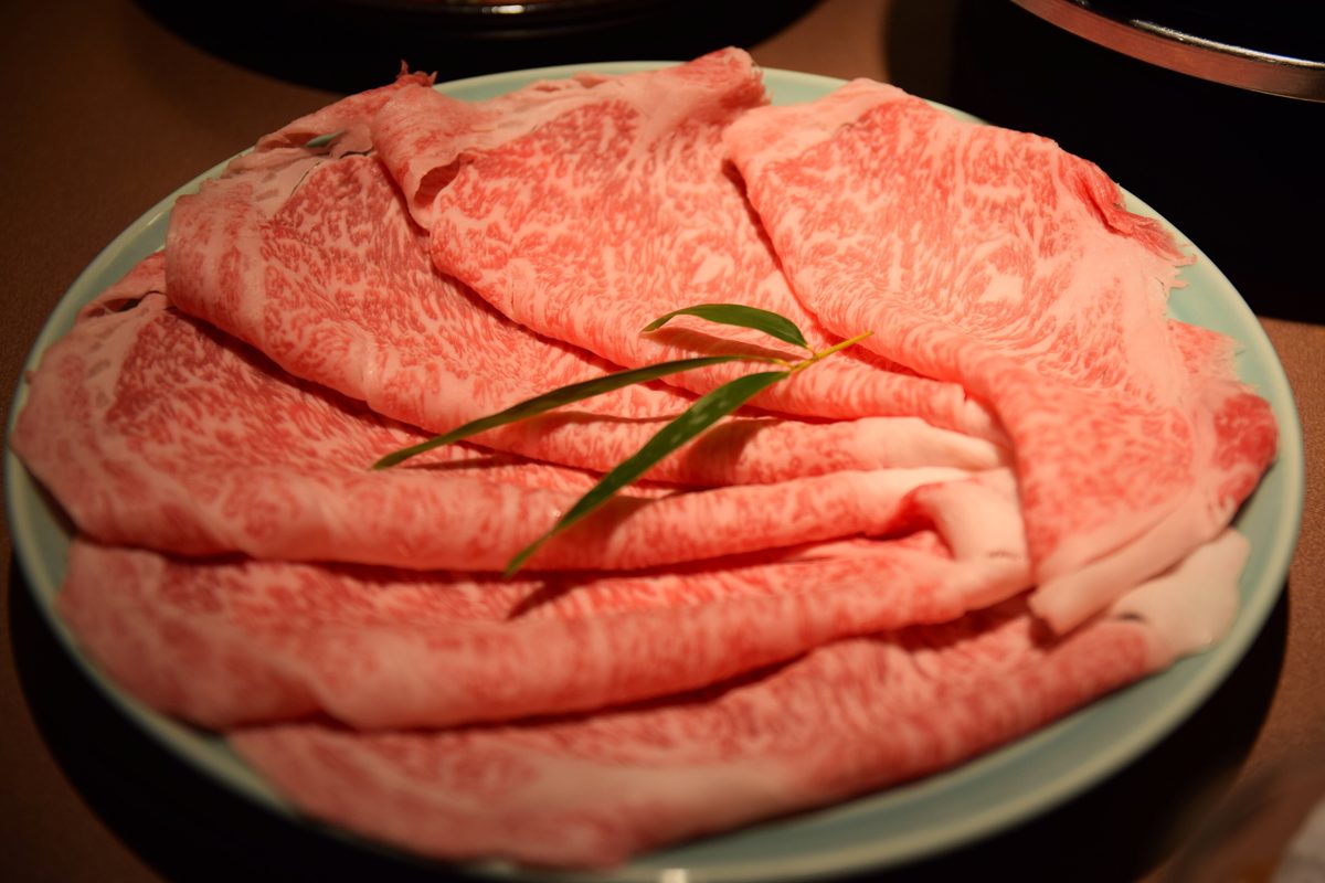 Plate of thinly sliced marbled wagyu beef