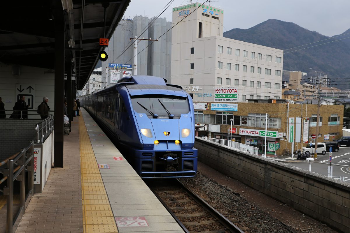 A blue JR Kyushu Sonic express train at a platform of Beppu Station