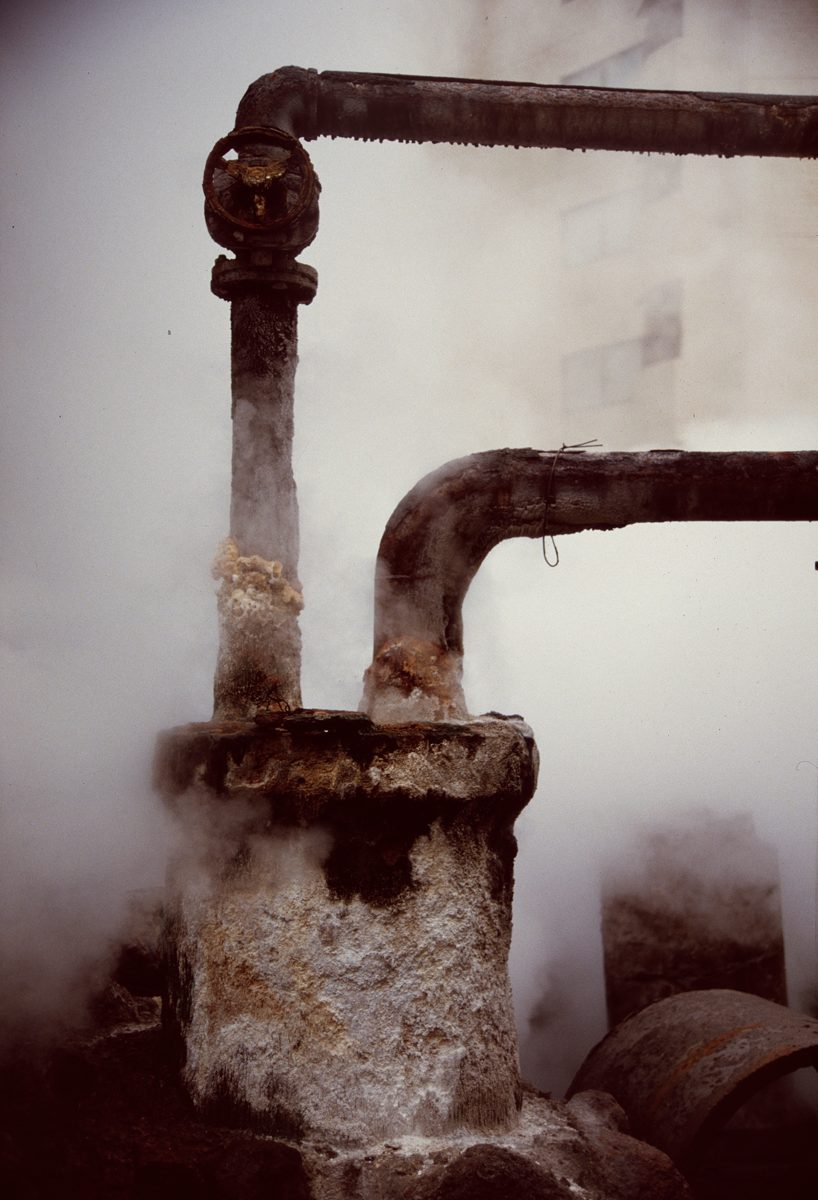 Steam pouring from a rusty pipe
