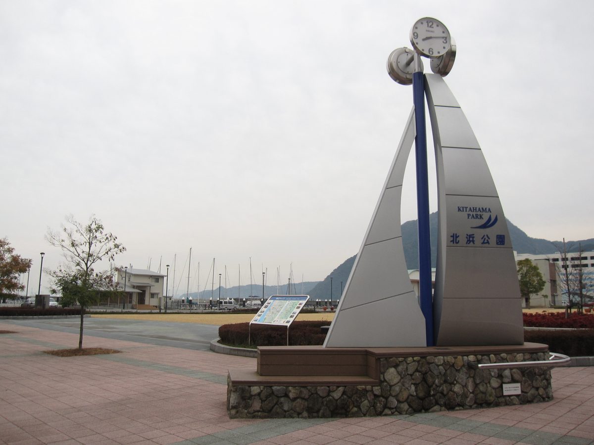 Clock monument in Kitahama Park on the Beppu waterfront under a cloudy sky