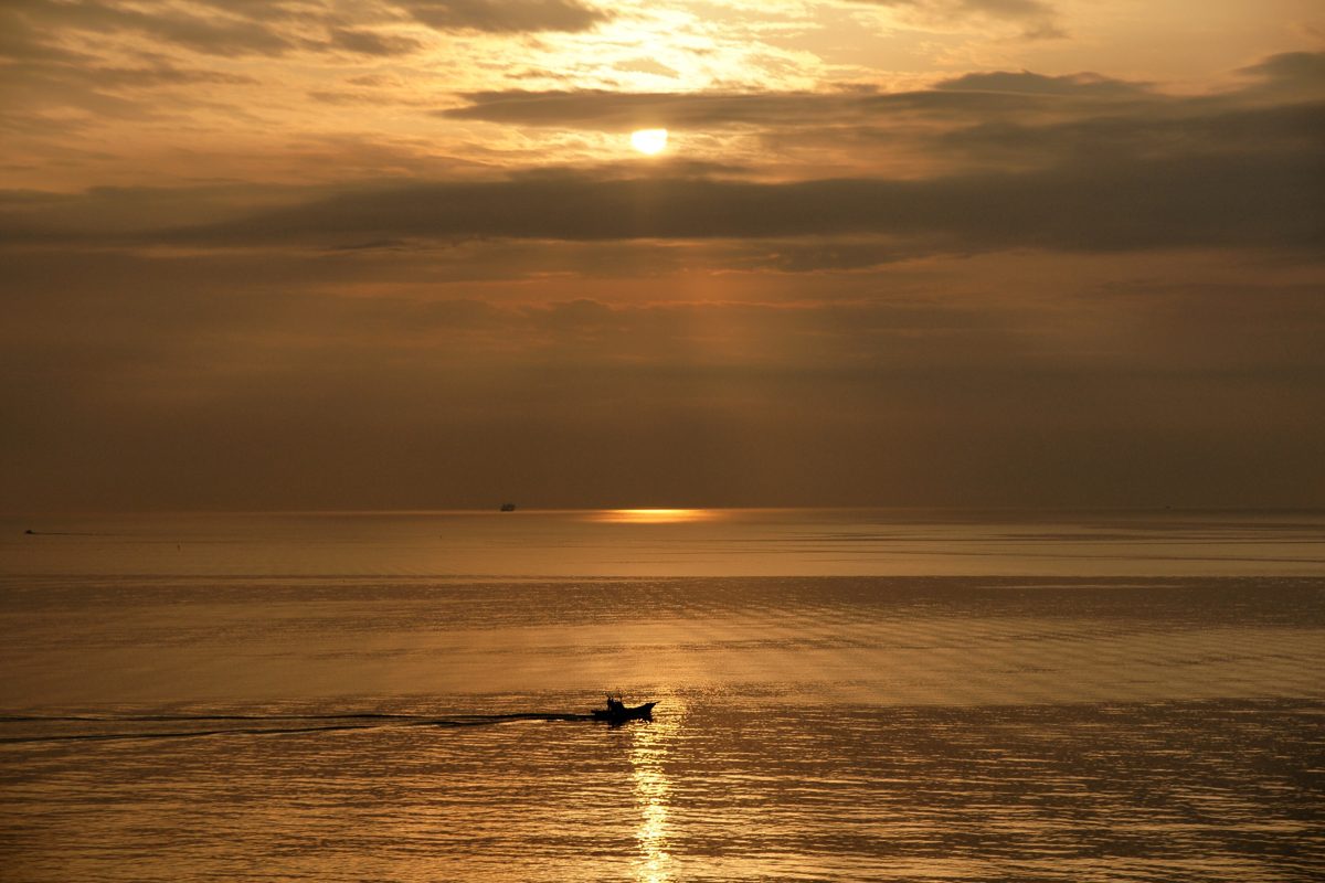 Sunset over Beppu Bay with a small boat on the water