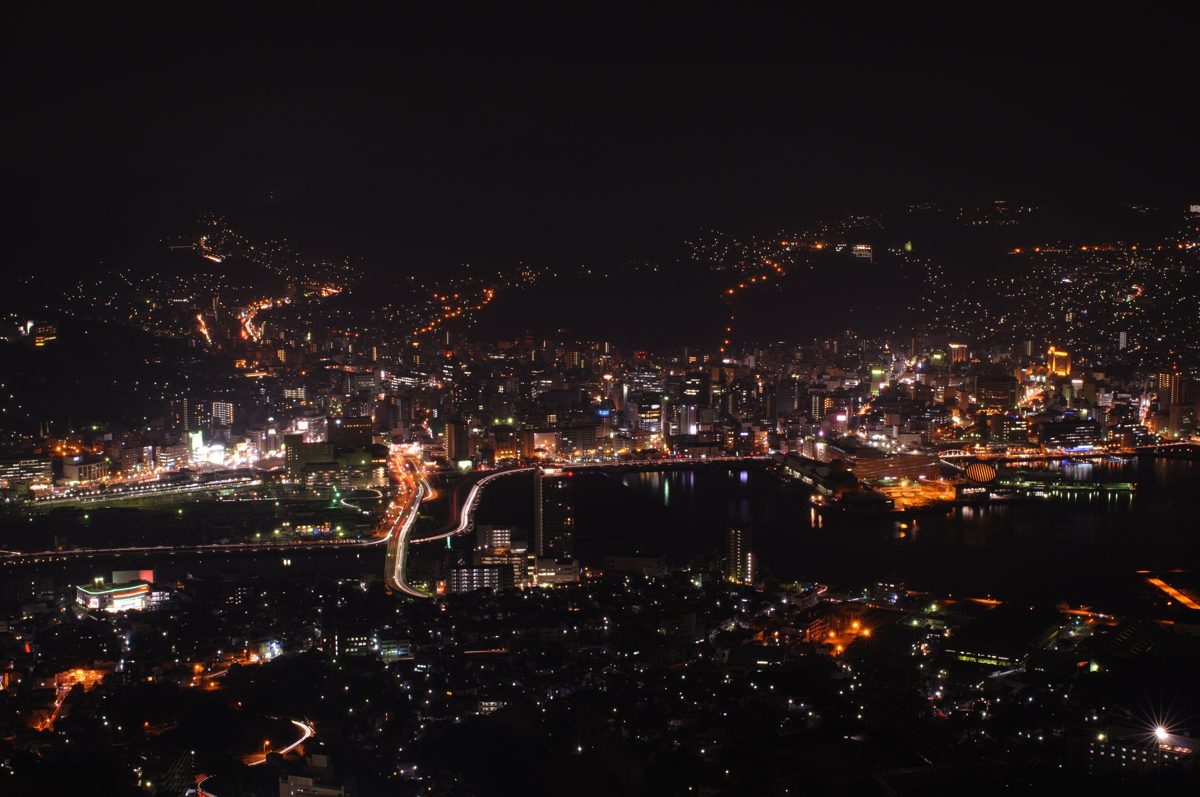 City lights around Nagasaki Harbor at night seen from a mountain