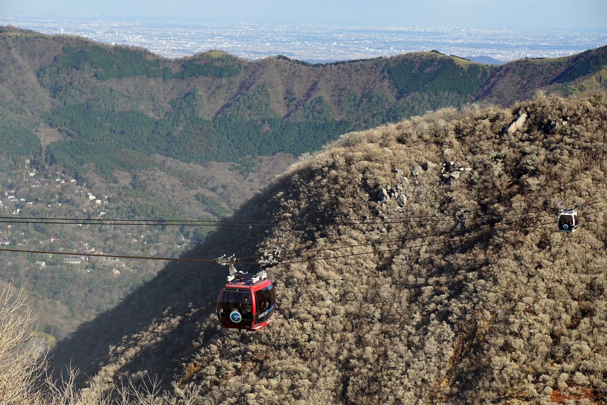 Hakone Ropeway gondolas crossing above the bare volcanic slopes of Owakudani