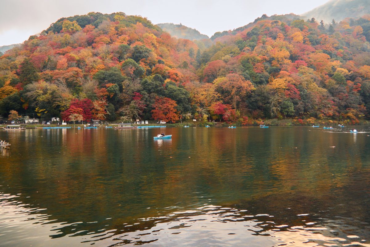 Autumn hills above the Oi River in Arashiyama with small boats