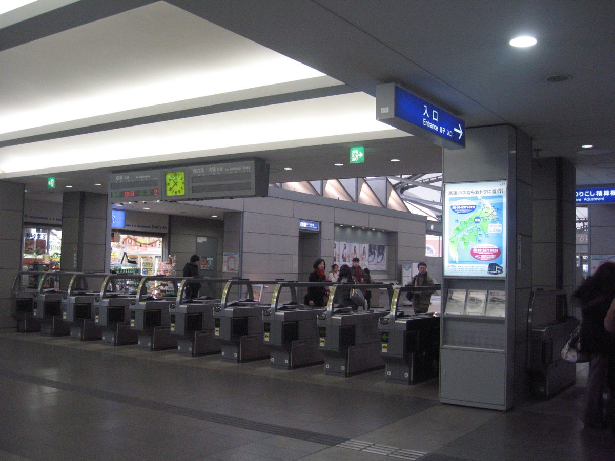 Ticket gates inside a railway station concourse