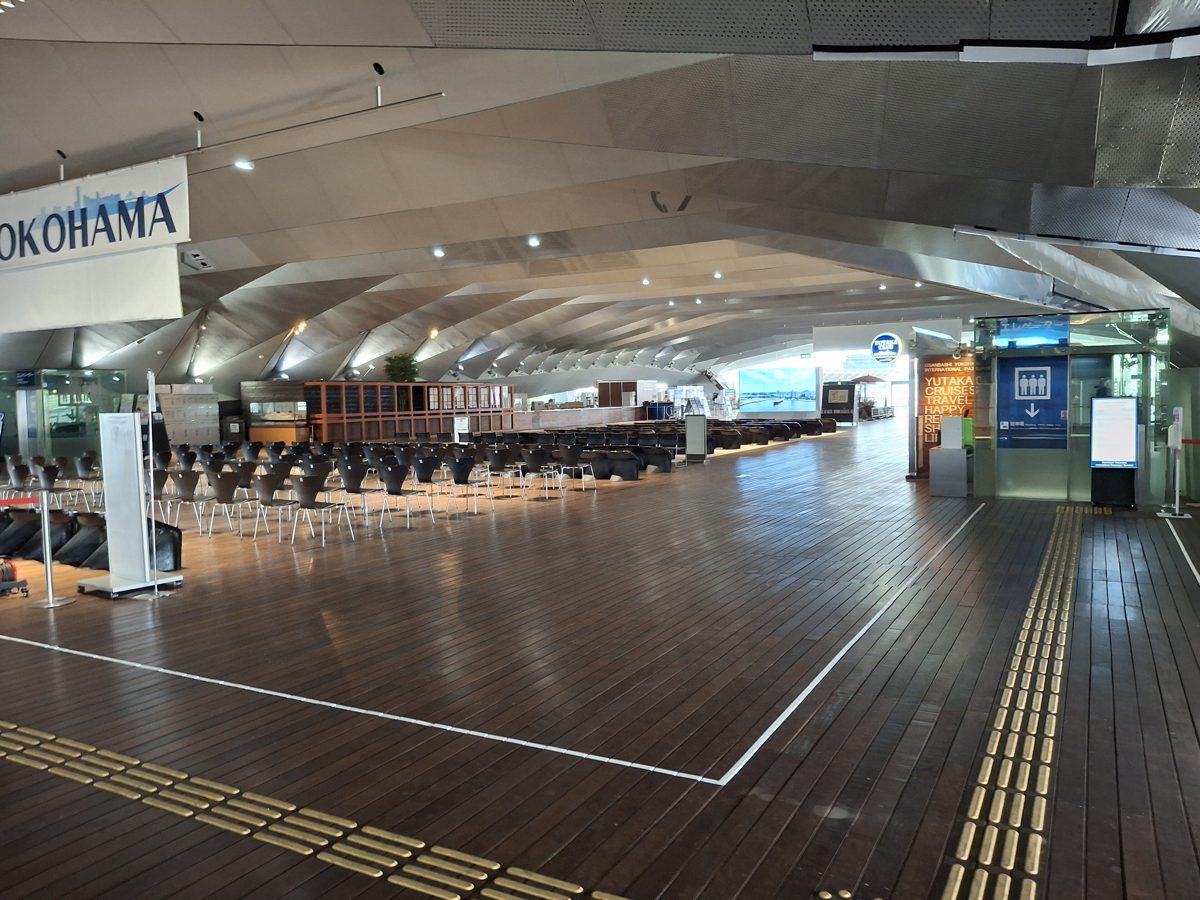 The wooden-floored passenger hall of Osanbashi terminal with rows of seats