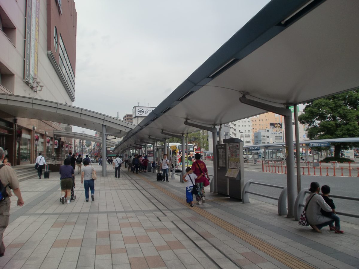 Covered bus stop area along the sidewalk at the entrance of Kagoshima-Chuo Station