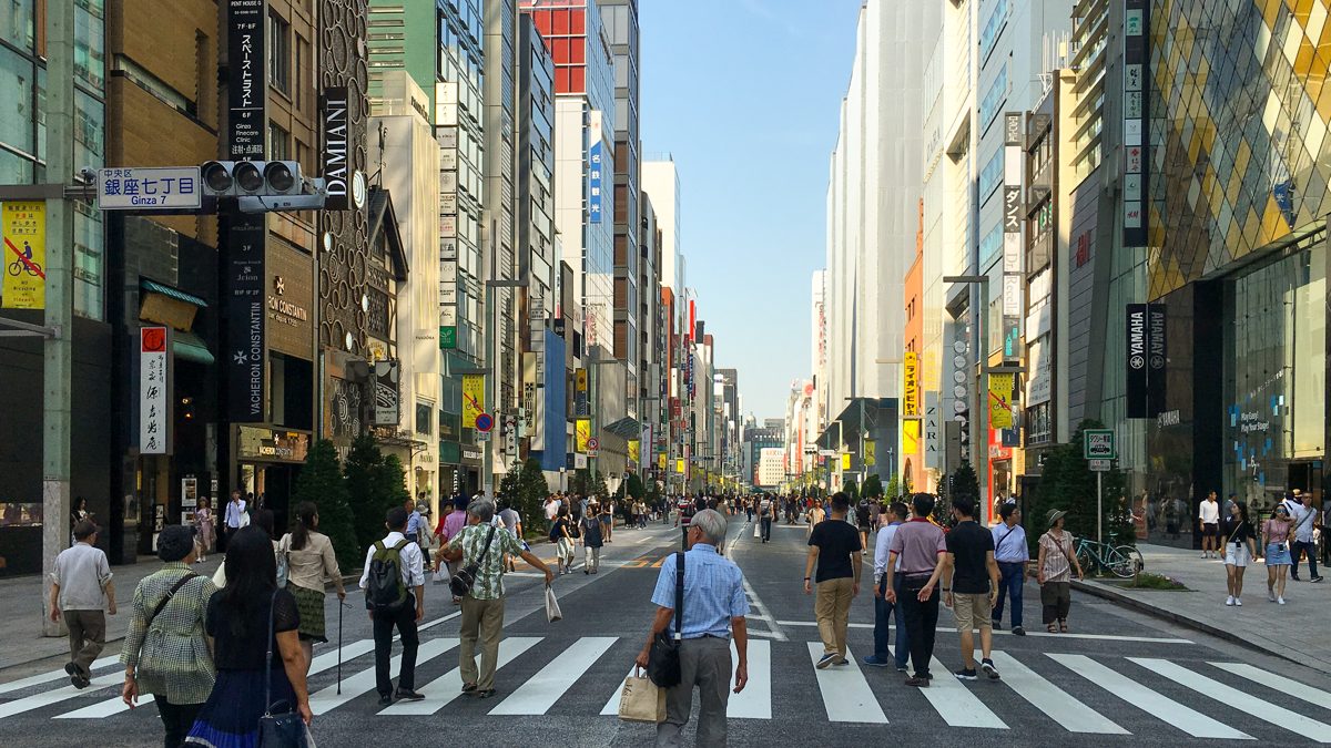 Chuo-dori in Ginza closed to cars, with pedestrians walking between tall shop buildings