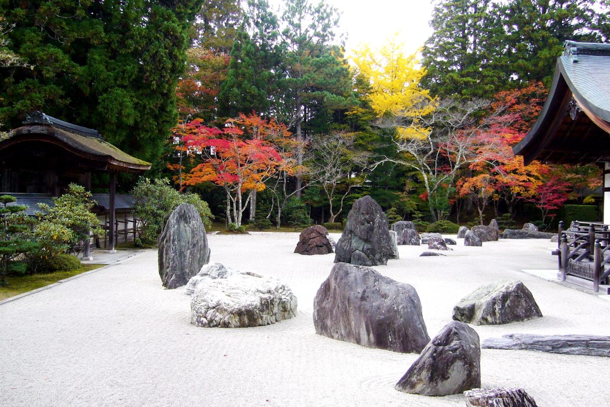 Rock garden with large stones on white gravel and autumn trees at Kongobuji, Koyasan