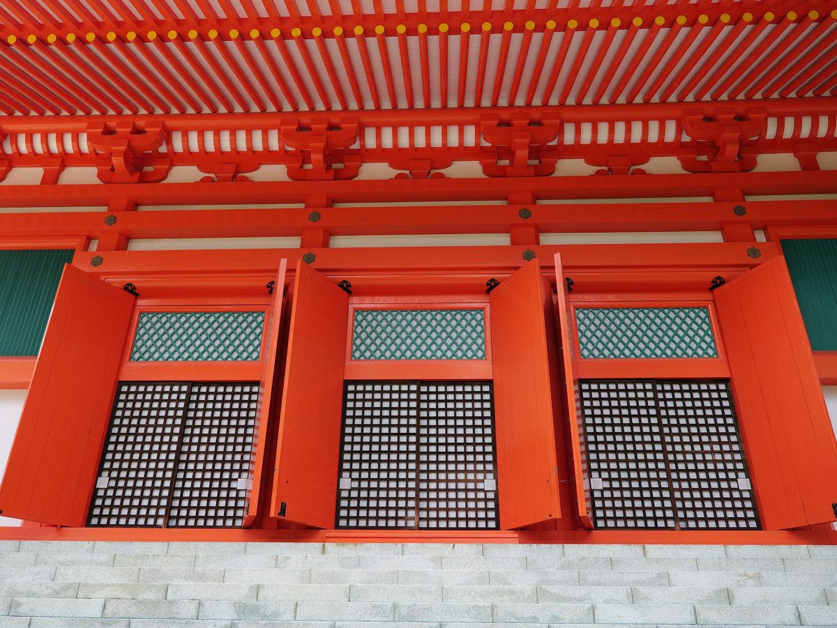 Close view of a red temple hall with lattice windows at Danjo Garan on Koyasan