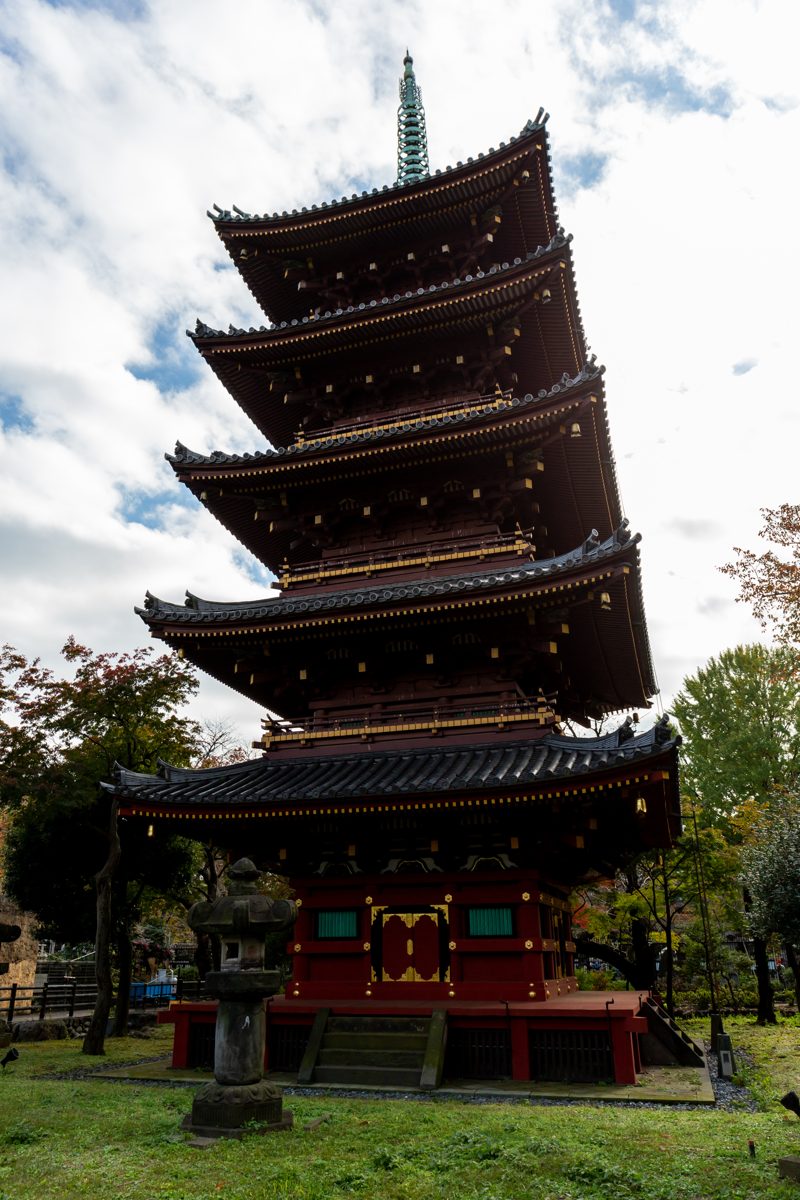 A red five-story pagoda among trees