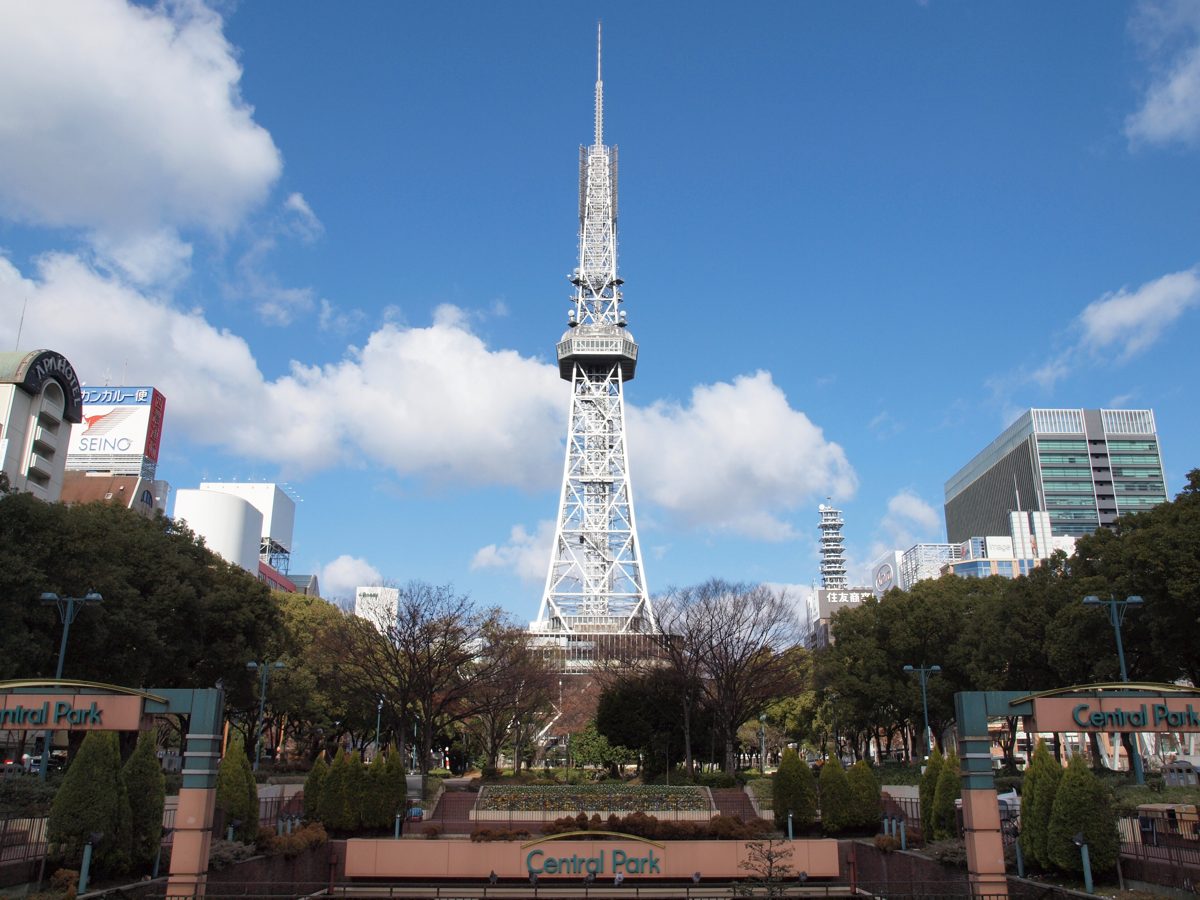 Nagoya TV Tower rising above trees and a garden path in Hisaya Odori Park