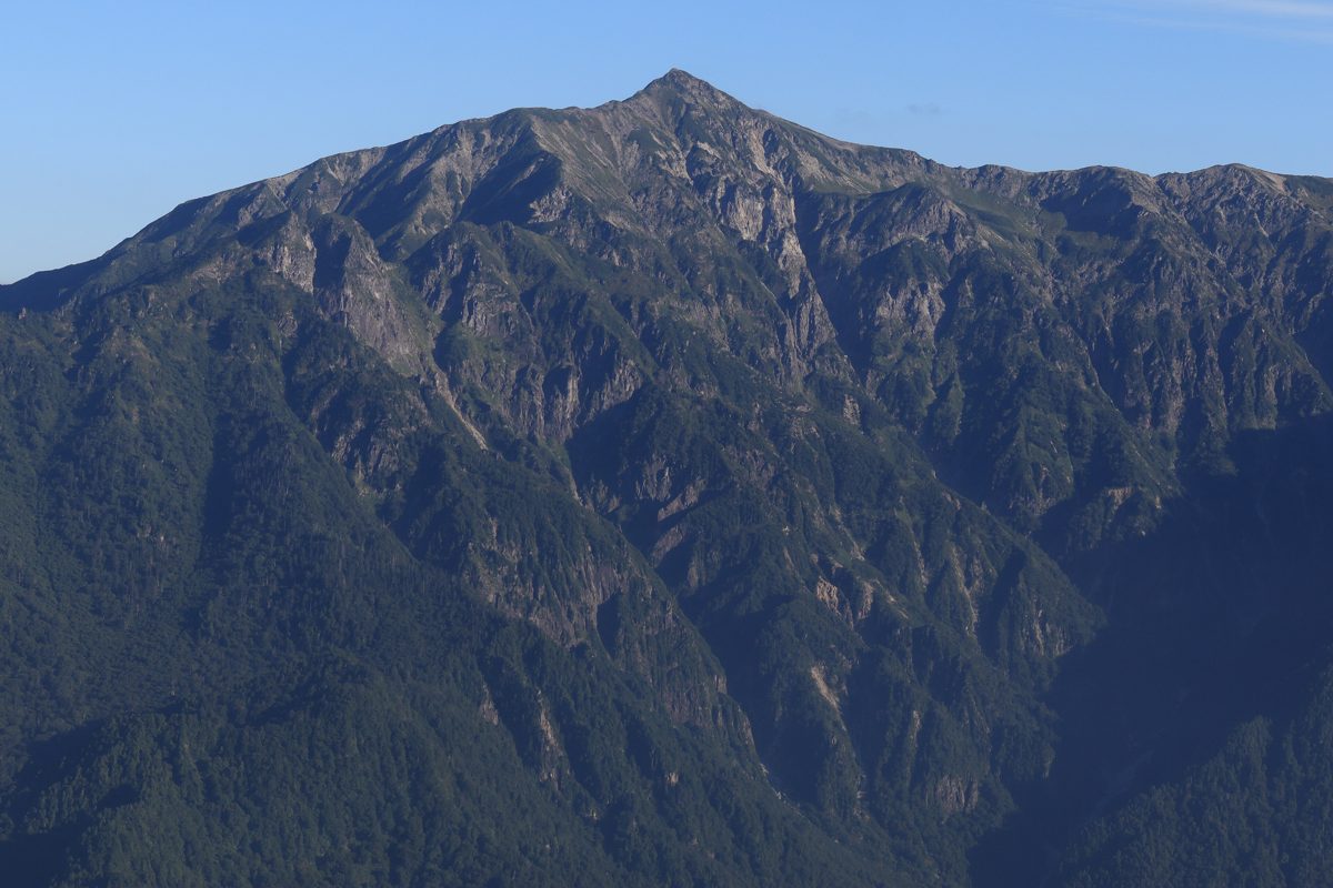 The dark ridges of Mount Kasa against a clear blue sky