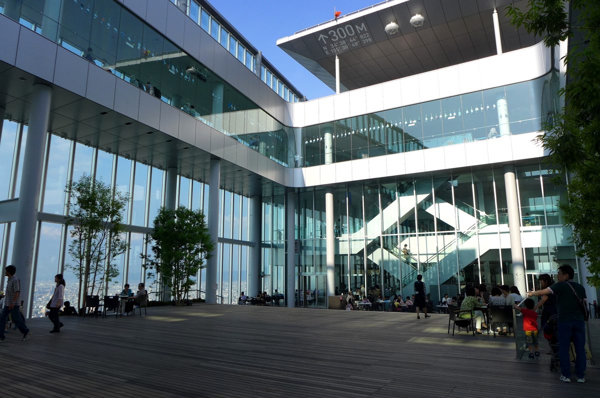 The open-air wooden deck of the Sky Garden with glass walls and a 300 m sign overhead