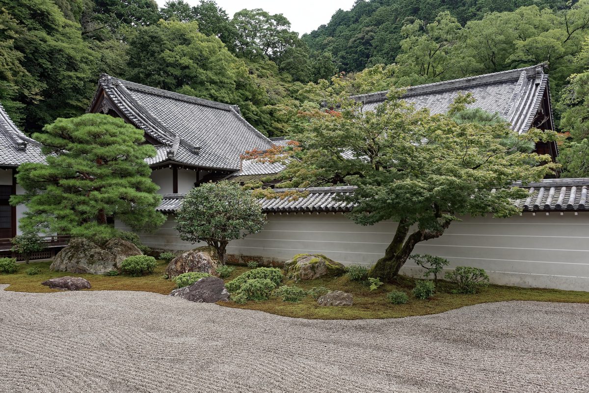 A raked gravel garden with pine trees and temple buildings at Nanzenji