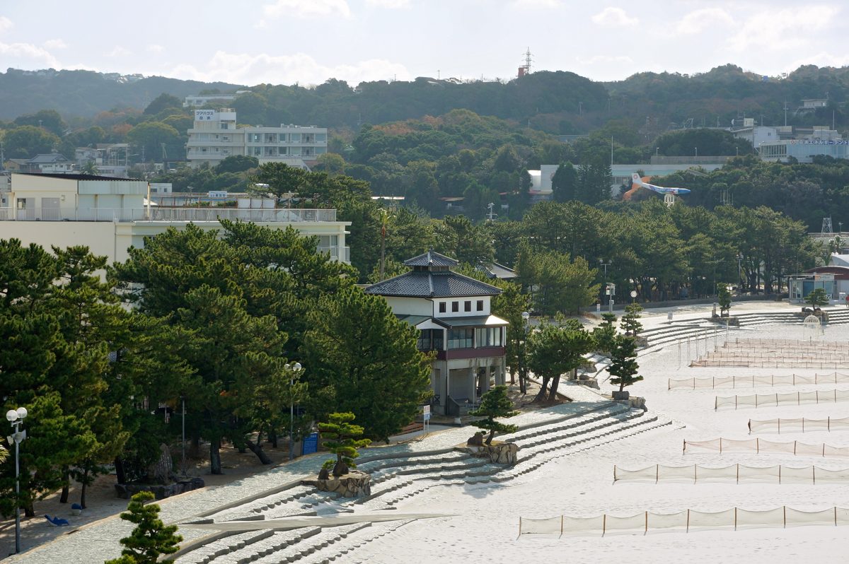 Shirahama Onsen town with trees, hotels and a white sand beach seen from above