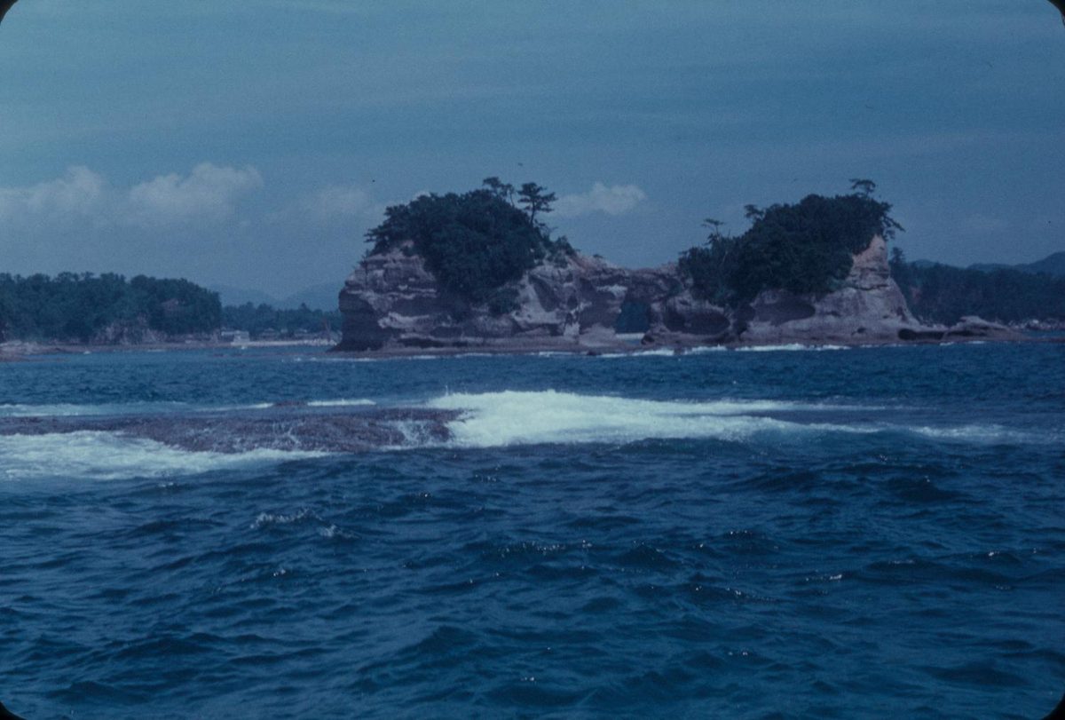 Engetsu Island, a rocky islet with trees on top, in a blue sea