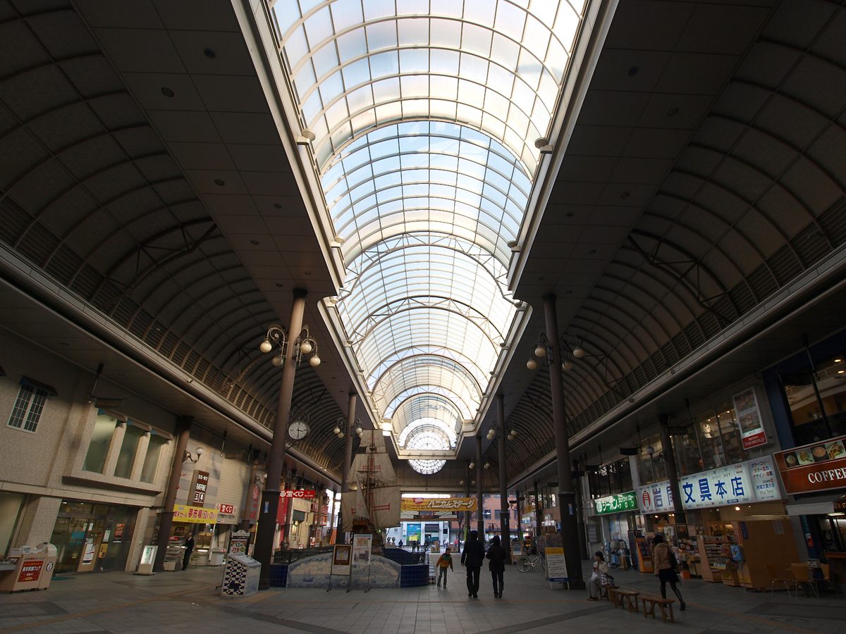 A long covered shopping arcade with a glass roof
