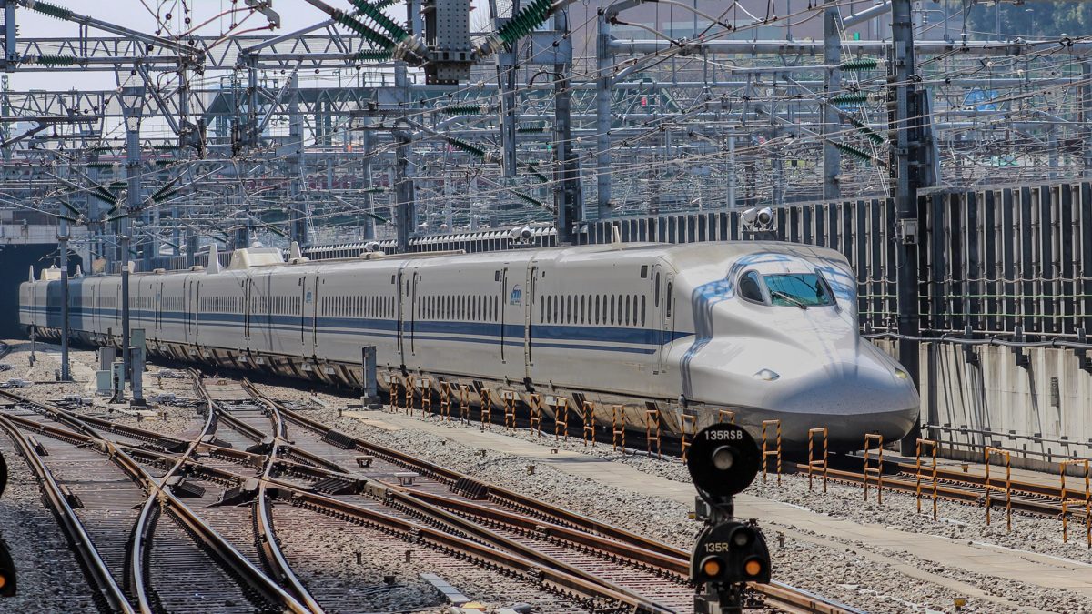 White N700 Series Shinkansen train running on tracks near Tokyo