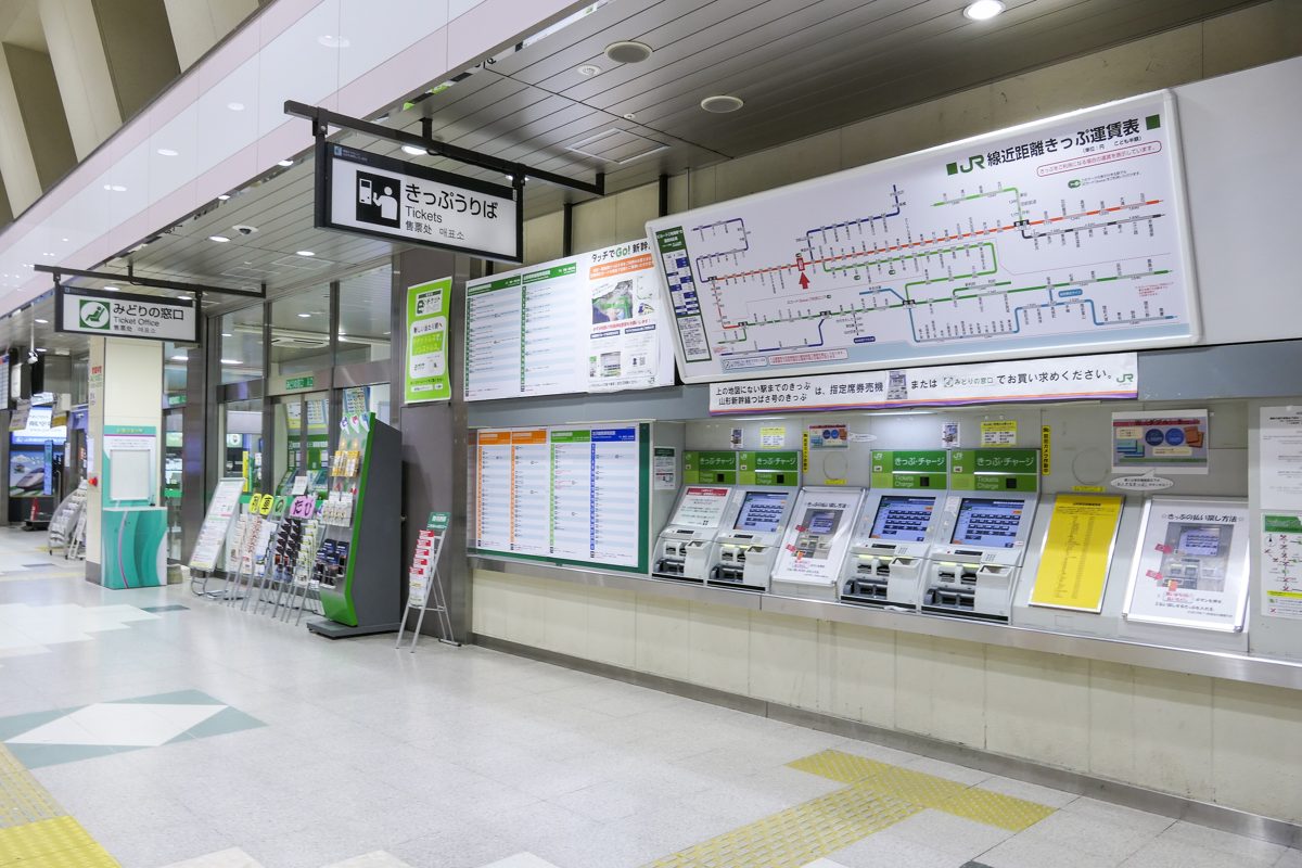 Ticket machines and a fare map at a JR station ticket area